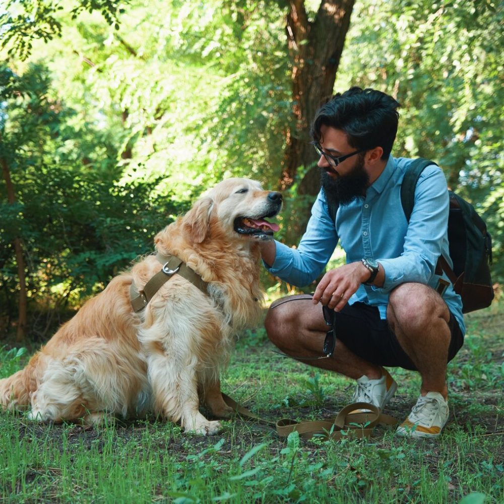handsome-young-man-with-golden-retriver-outdoors_158595-4257